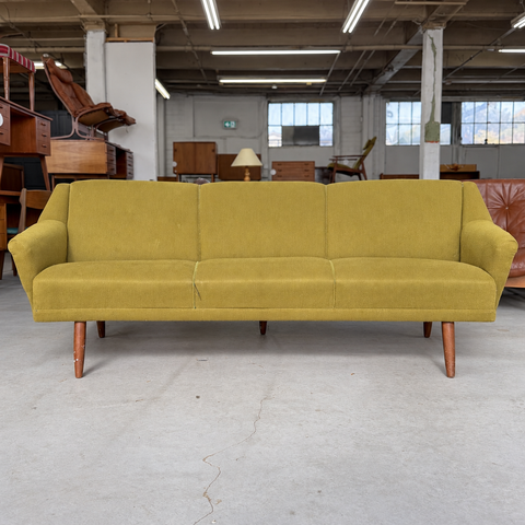 Vintage Danish curved upholstered sofa — showroom view
