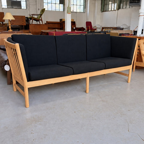 Black Upholstered Oak Sofa — full three-quarter view