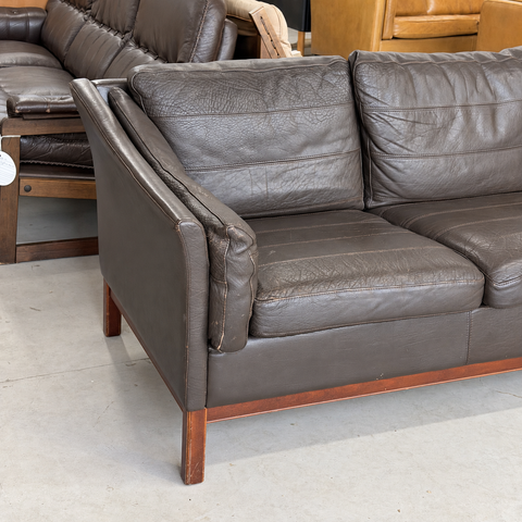 Stouby dark leather three-seater sofa — left arm and seat detail